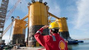Engineer looking up at platform under construction