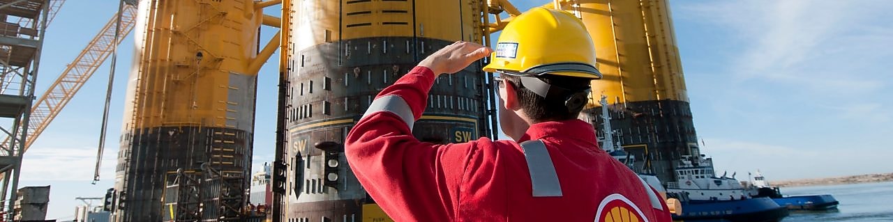 Engineer looking up at platform under construction