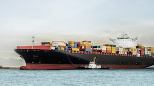 large tanker at sea loaded with container crates