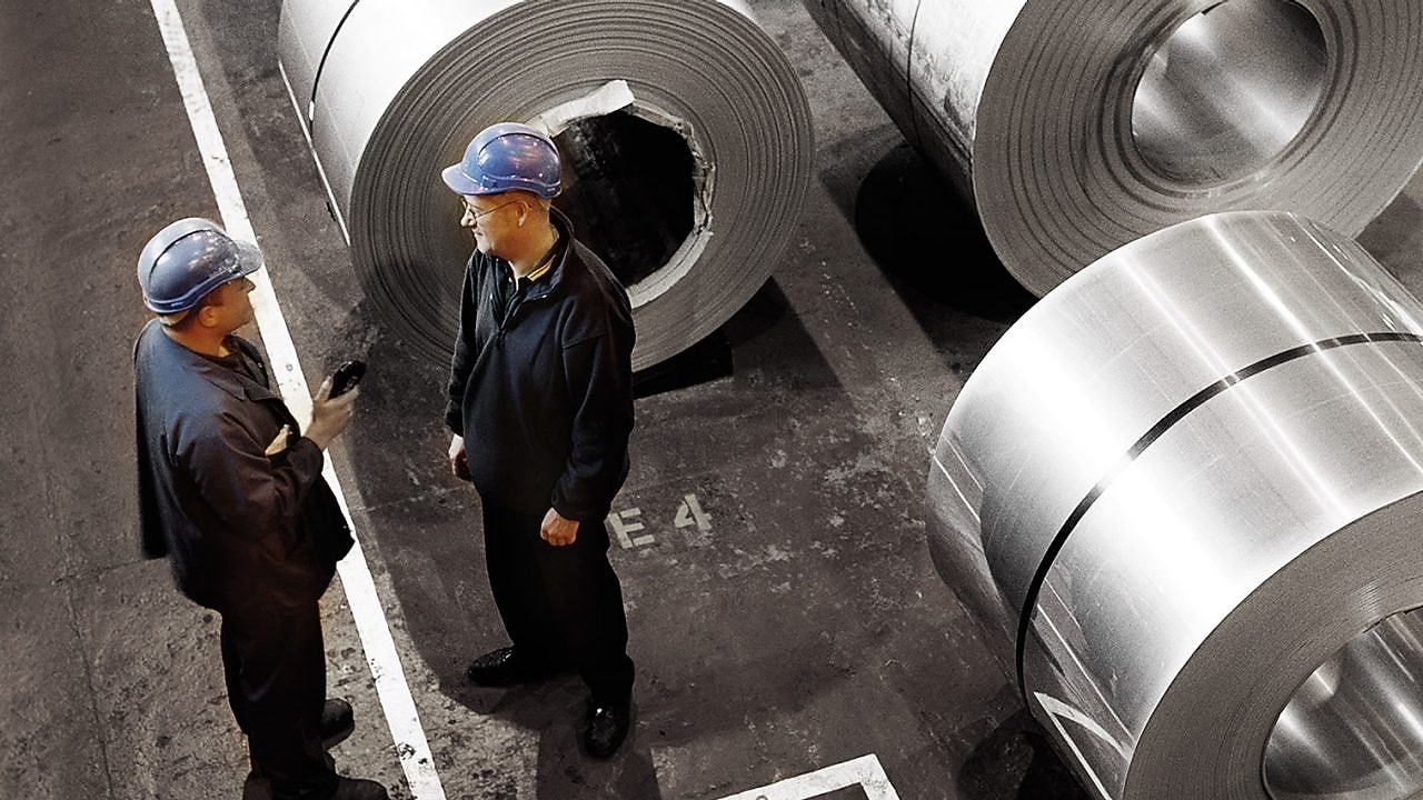 two workers in a metal factory
