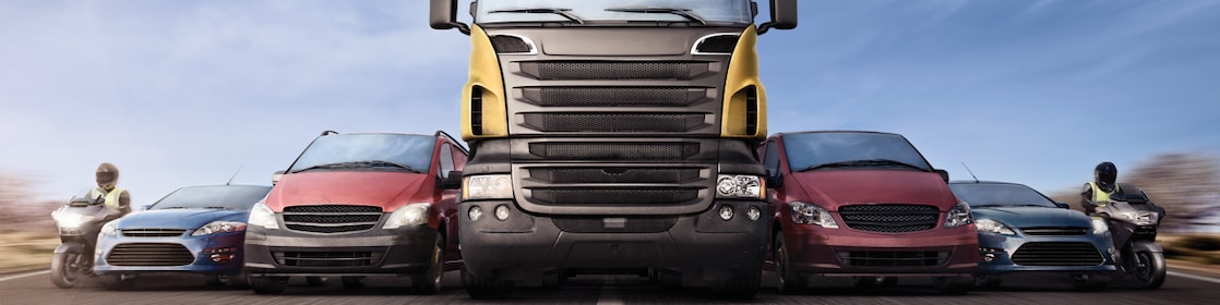 Motorcycles, cars and trucks on road