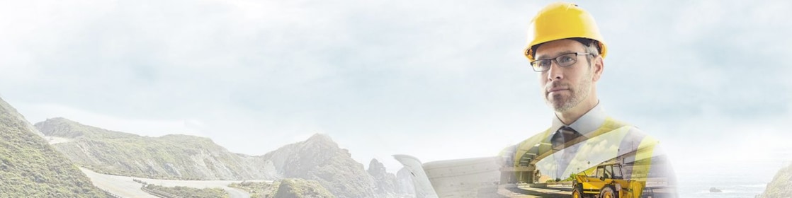 A worker in a yellow hard hat transposed onto a background og a road in some mountains