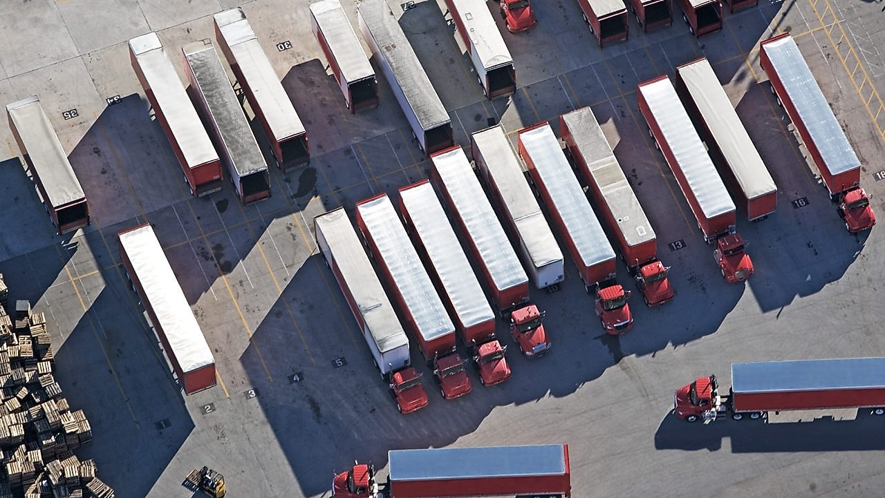 top down view of red lorries parked in a lorry park