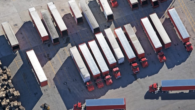 top down view of red lorries parked in a lorry park