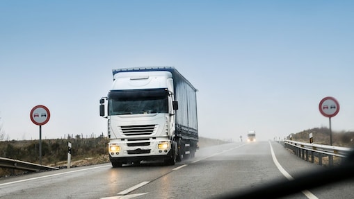 road with two heavy trucks coming