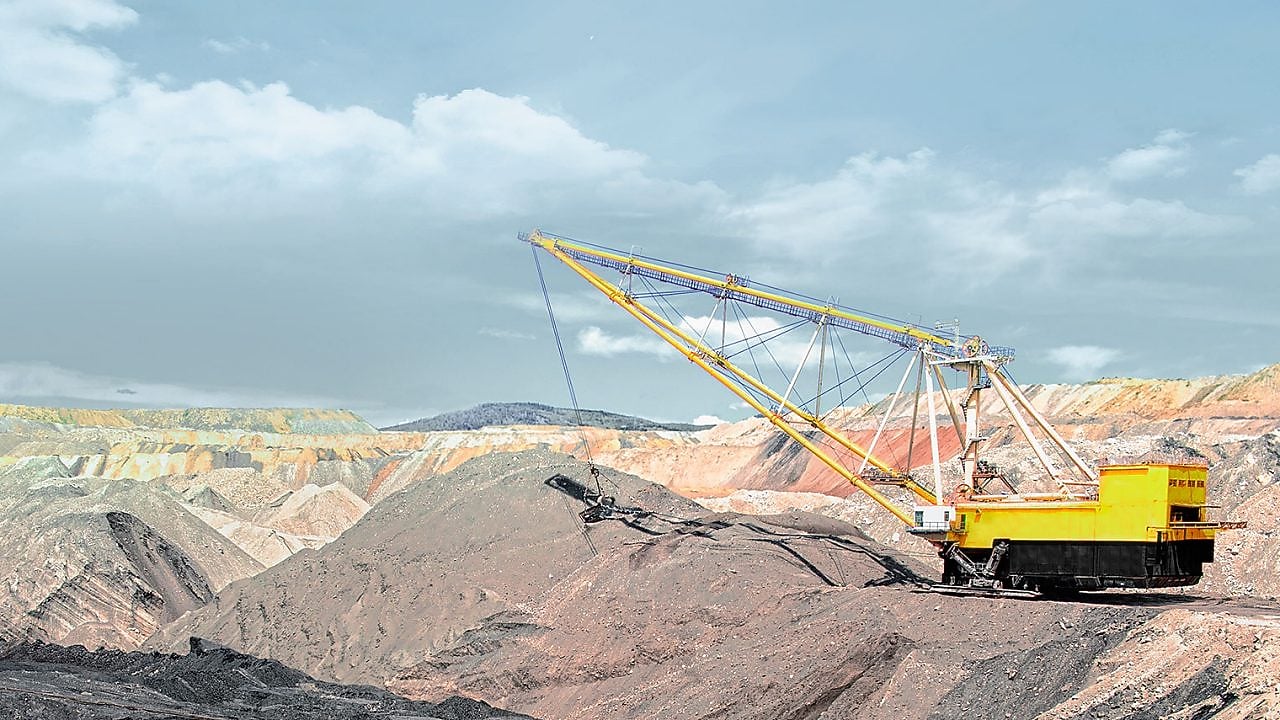 yellow crane liftingmachinery in a rock mine