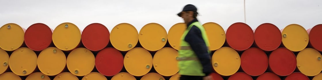 man walking barrels lubricants