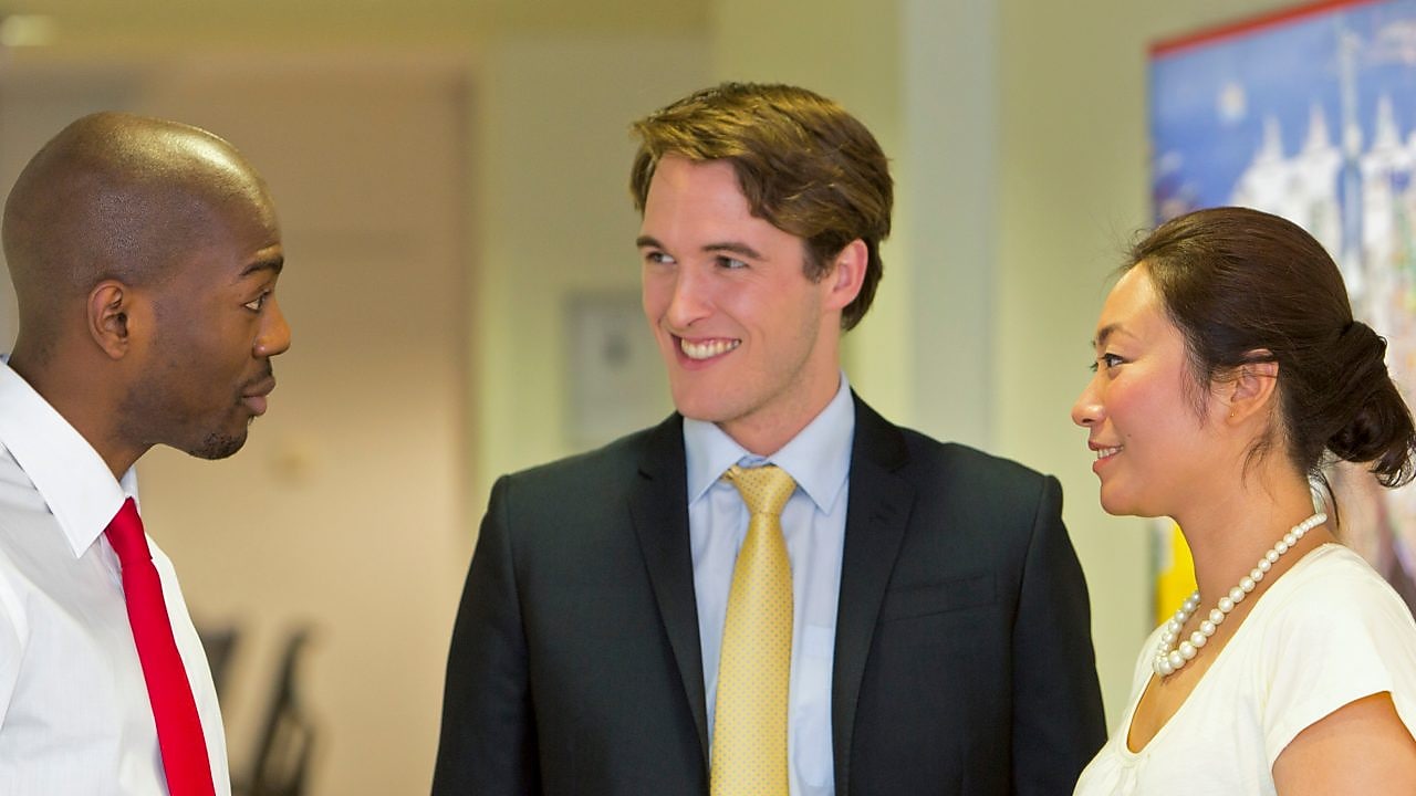 Three employees discussing work