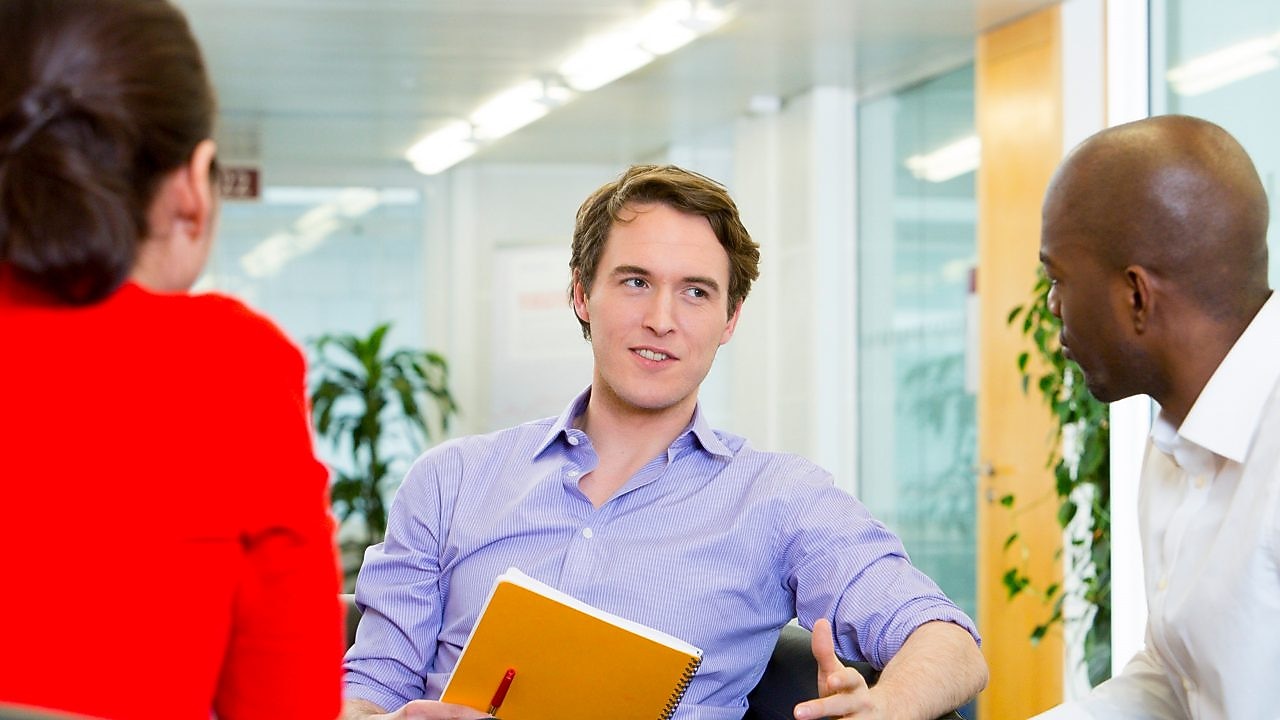 two employees interviewing a potential candidate