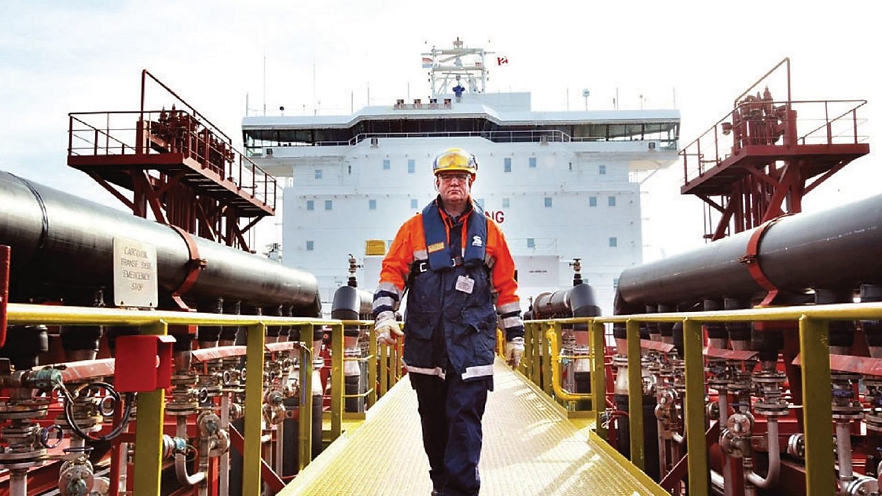 worker walking around a Shell vessel