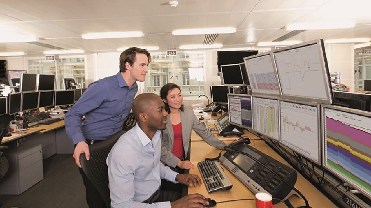 Staff on the Trading Floor examine data on multi computer screens