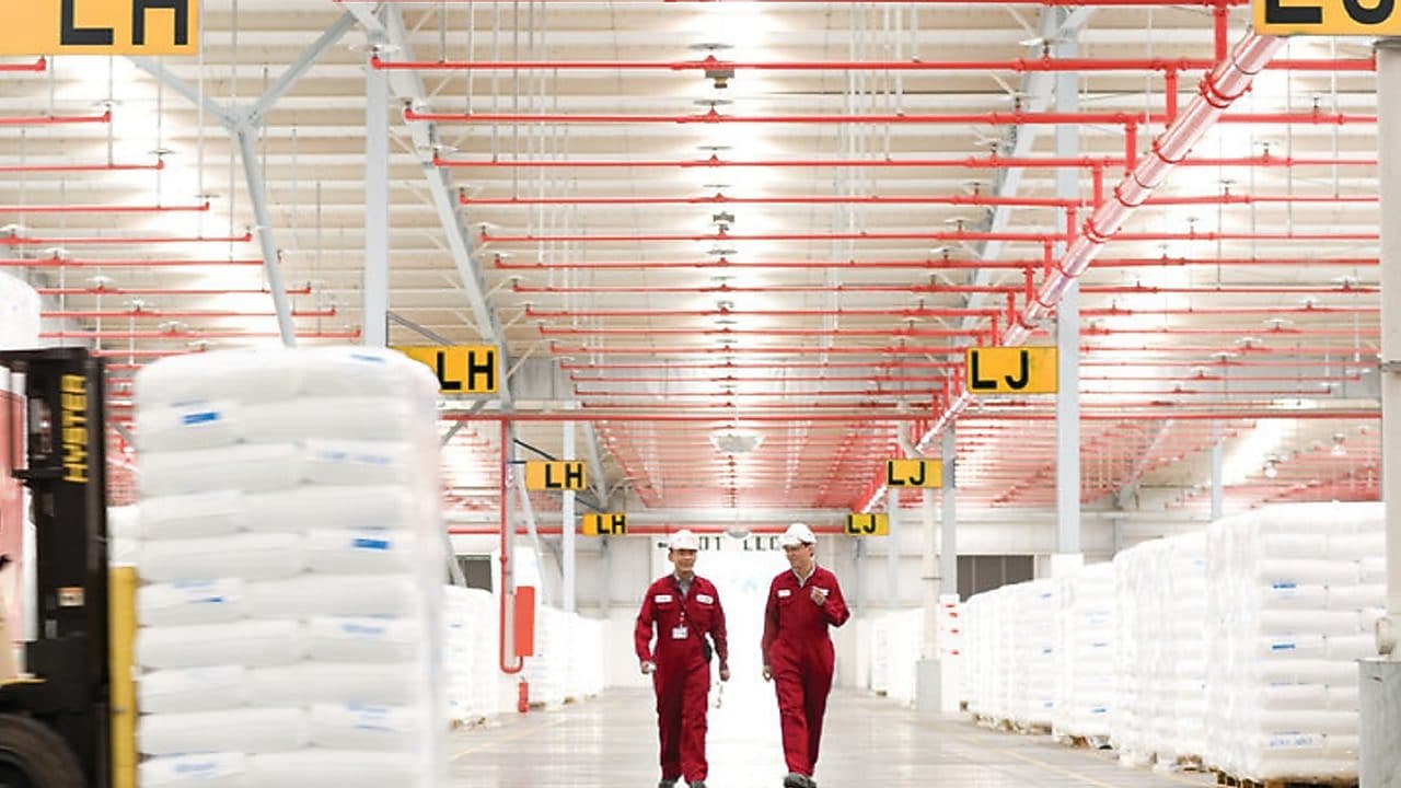 Two employees walking in a factory