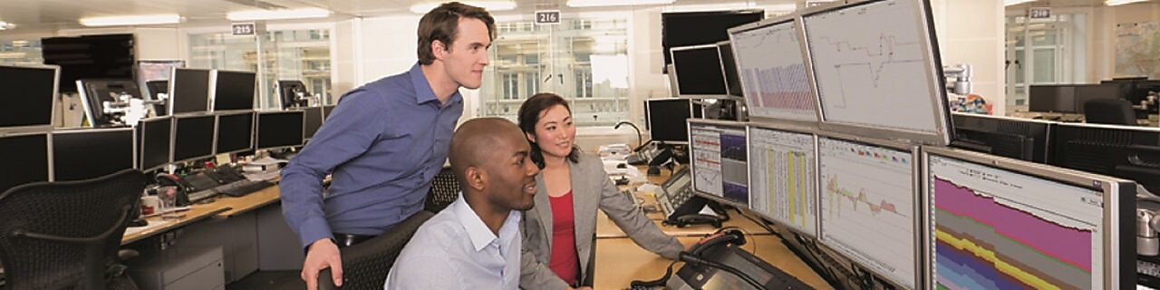 Staff on the Trading Floor examine data on multi computer screens
