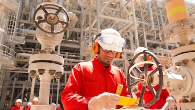 worker checking a valve