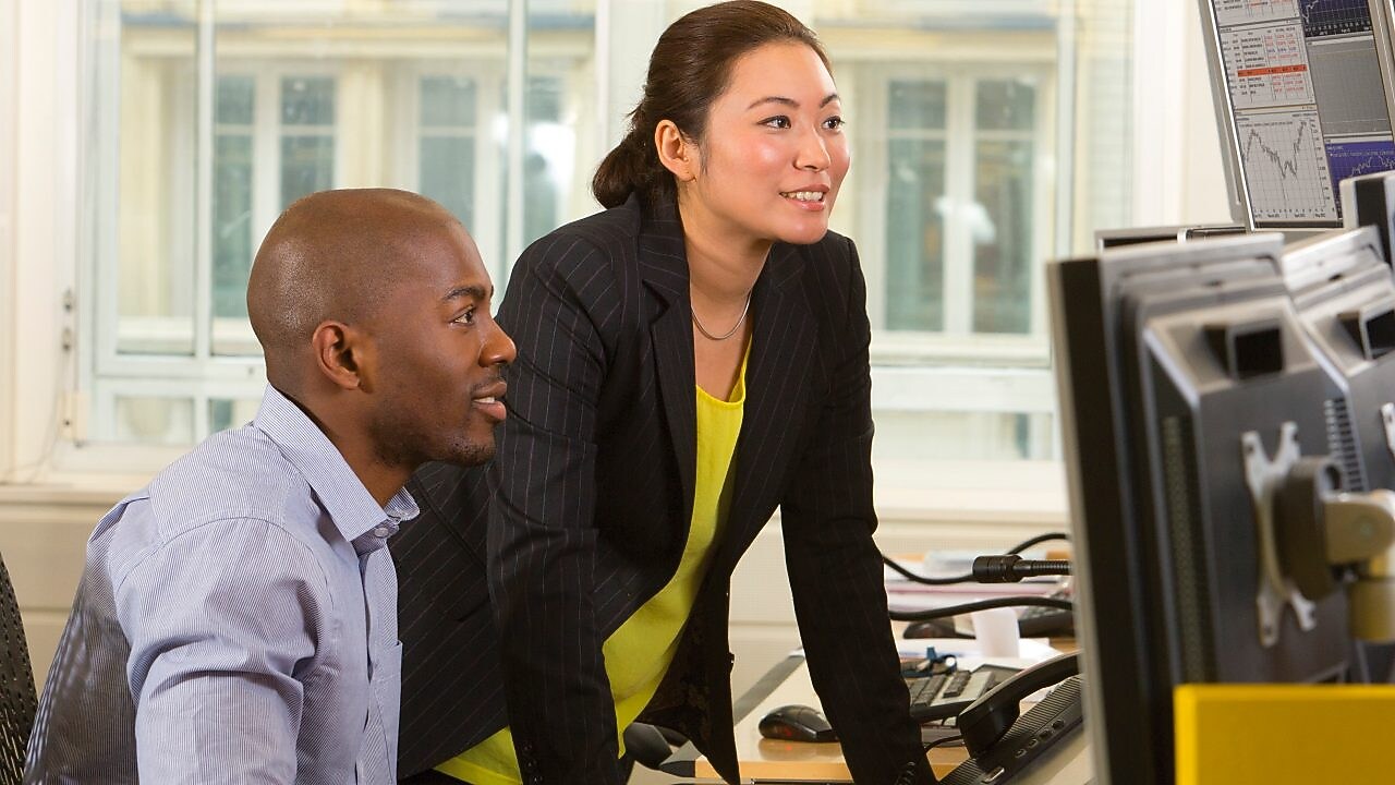 Employees looking at a computer screen