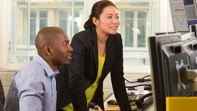 Employees looking at a computer screen