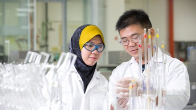 Two employees working in a production lab