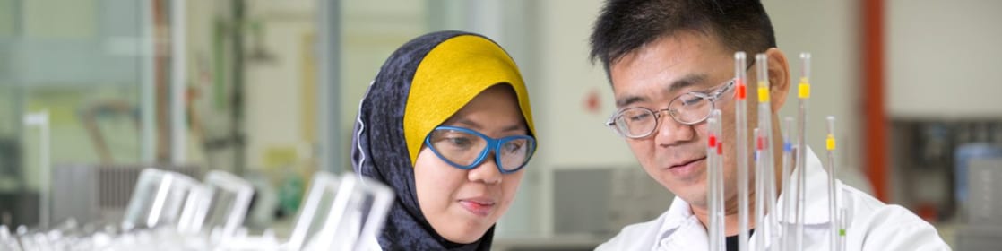 Two employees working in a production lab