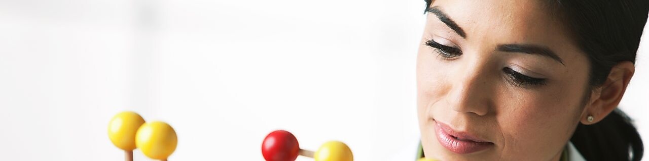 scientist looking at molecule model