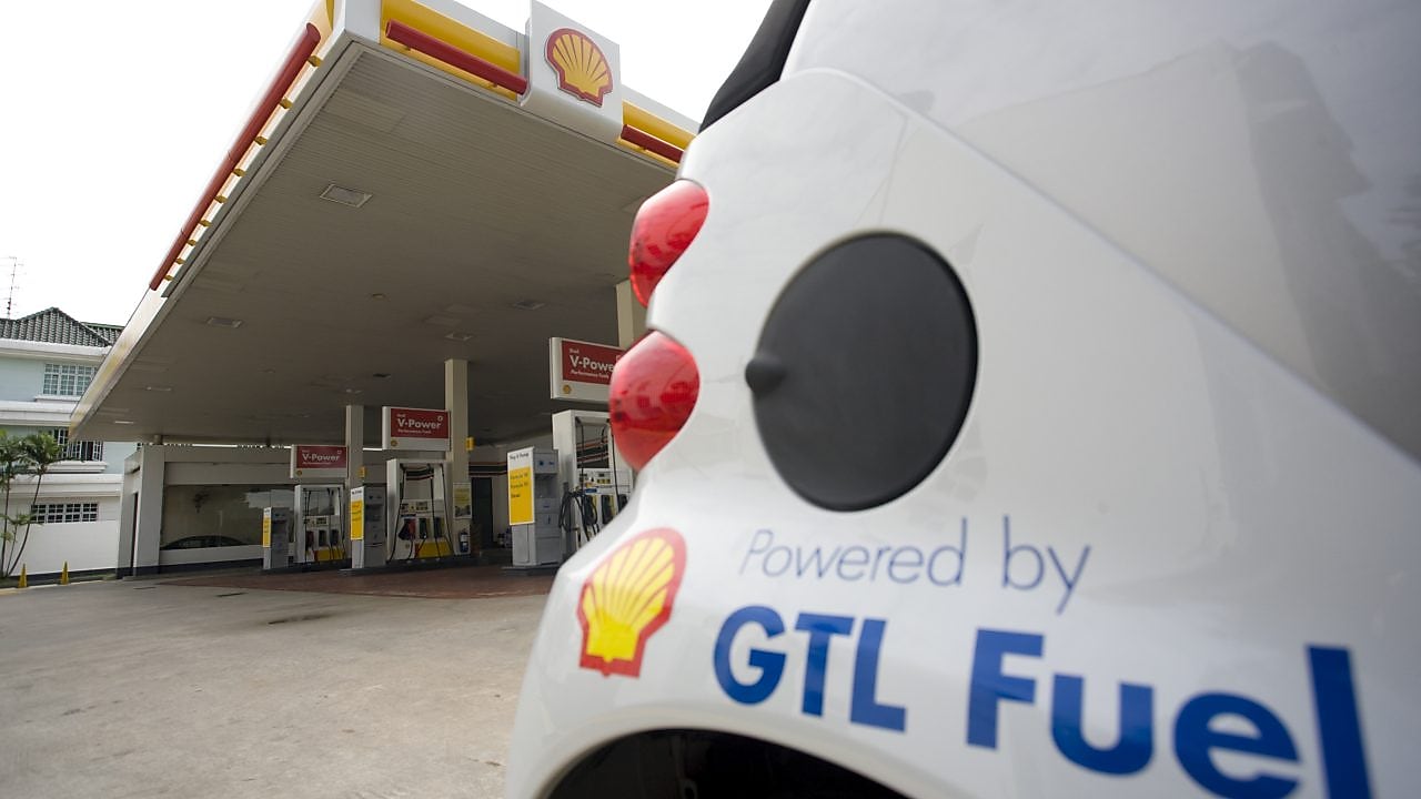 White car with GTL Fuel logo parked on a shell station