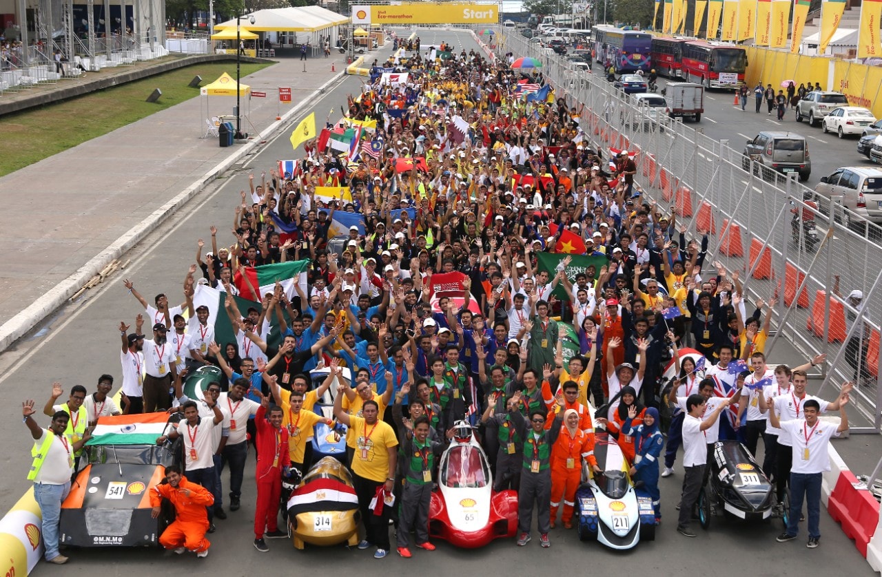 Participants pose with their vehicles during day one of the Shell Eco-marathon in Manila