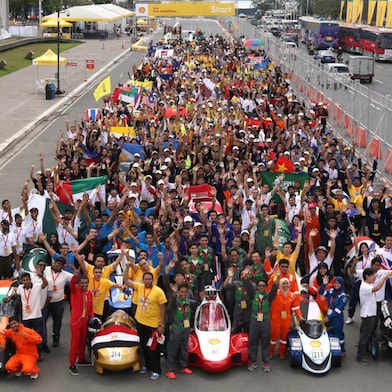 Participants pose with their vehicles during day one of the Shell Eco-marathon in Manila